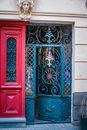 Exterior of aged house with ornamental door made of metal with sculpture above entrance in city street