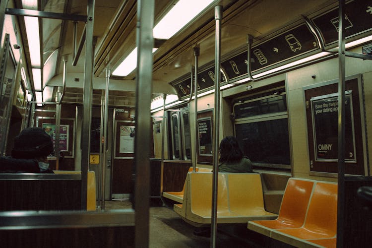 People Riding In Subway Train