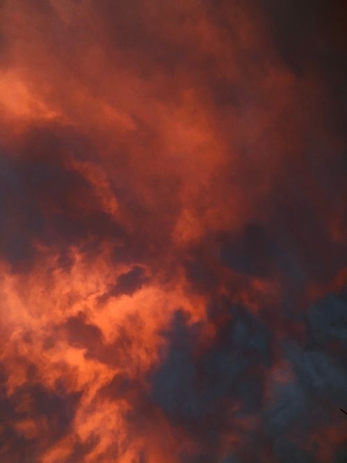 Free Stunning view of an orange glowing sky with dramatic clouds at sunset. Stock Photo