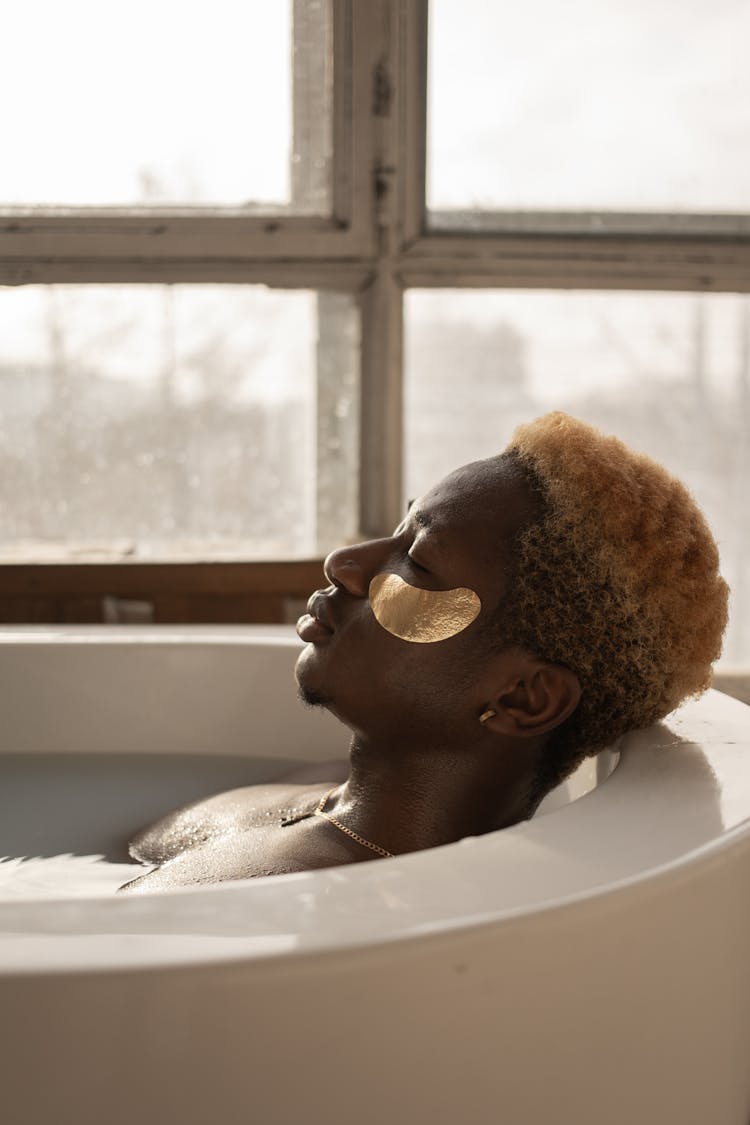 Relaxed Young Black Man Taking Bath With Closed Eyes