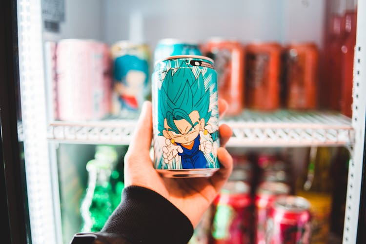 Close-Up Shot Of A Person Holding A Can Of Drink