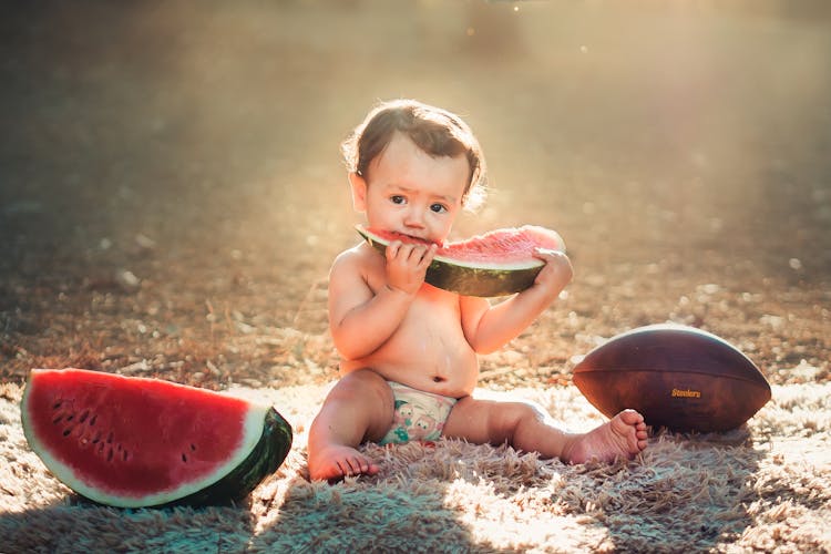 A Child Eating A Watermelon