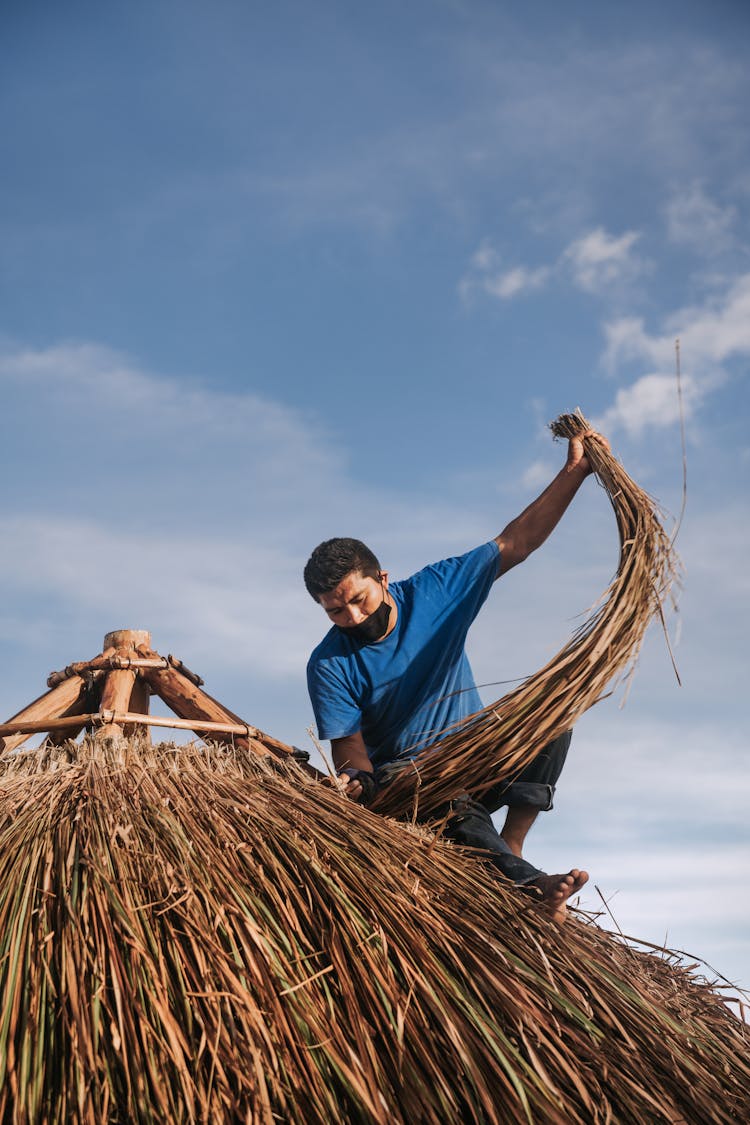 Man Working On Palapa Roof