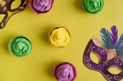 Free Colorful Cupcakes And Masks On Yellow Backg Stock Photo