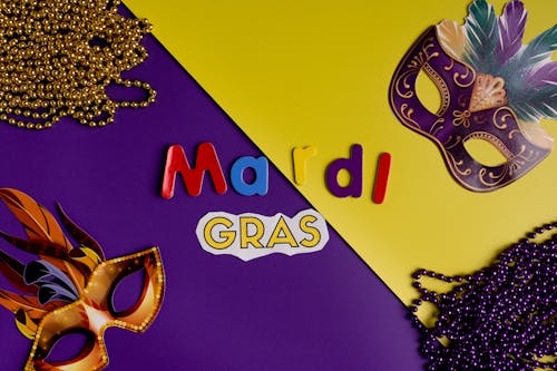 Masks And Beads On Yeloow And Purple Background