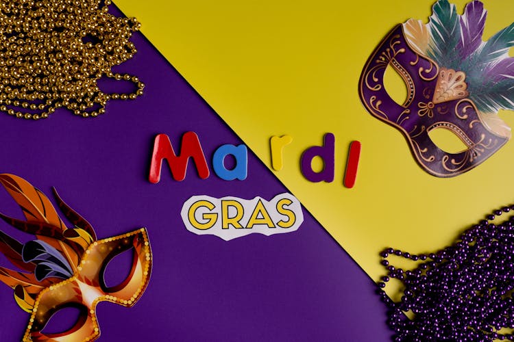 Masks And Beads On Yeloow And Purple Background