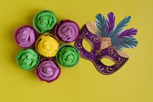 Free Colorful Cupcakes And Mask On Yellow Background Stock Photo