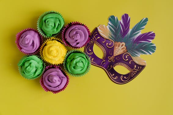 Colorful Cupcakes And Mask On Yellow Background