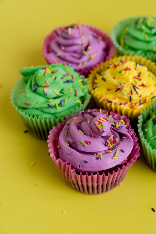 Free Creamy Cupcakes On Yellow Background Stock Photo