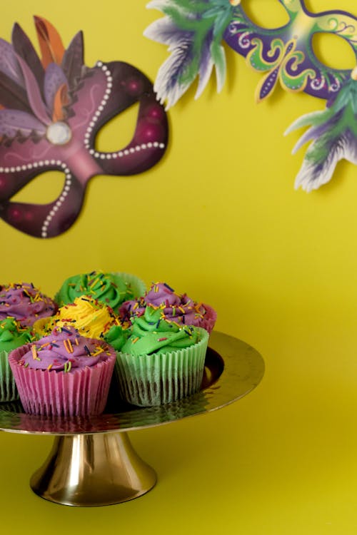 Free Colorful Cupcakes And Masks With Yellow Background Stock Photo
