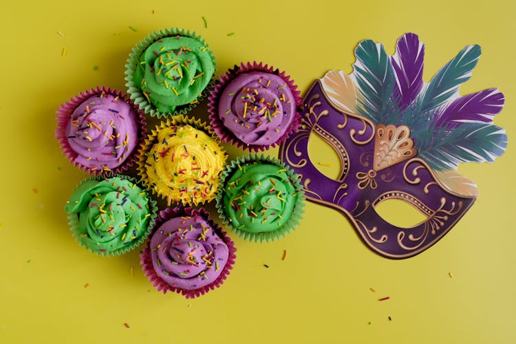 Colorful Pastries And Mask On Yellow Background