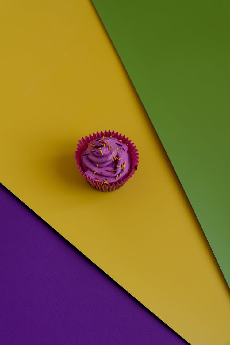 Purple Cupcake On Colorful Background