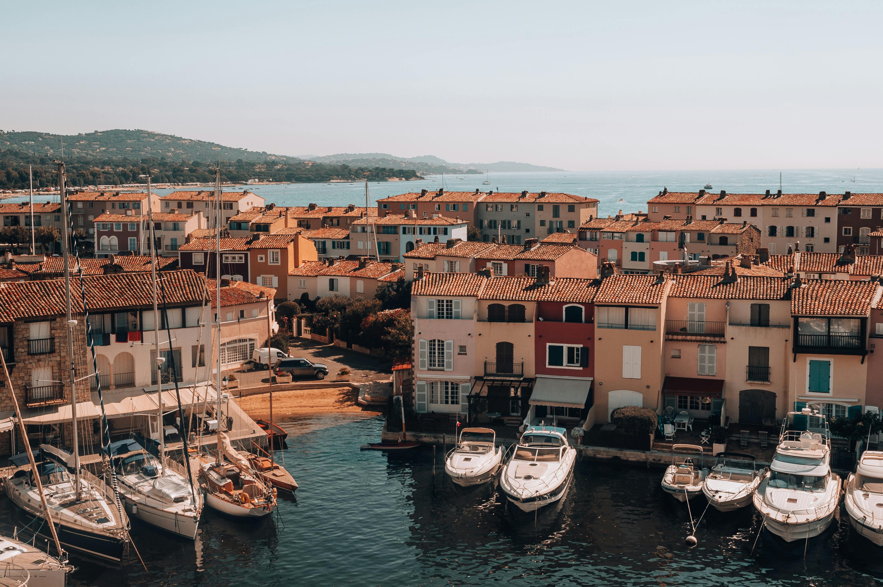 Free A picturesque view of docked boats in a charming coastal village under a clear sky. Stock Photo
