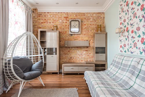 Living room interior with sofa and armchair near cabinets