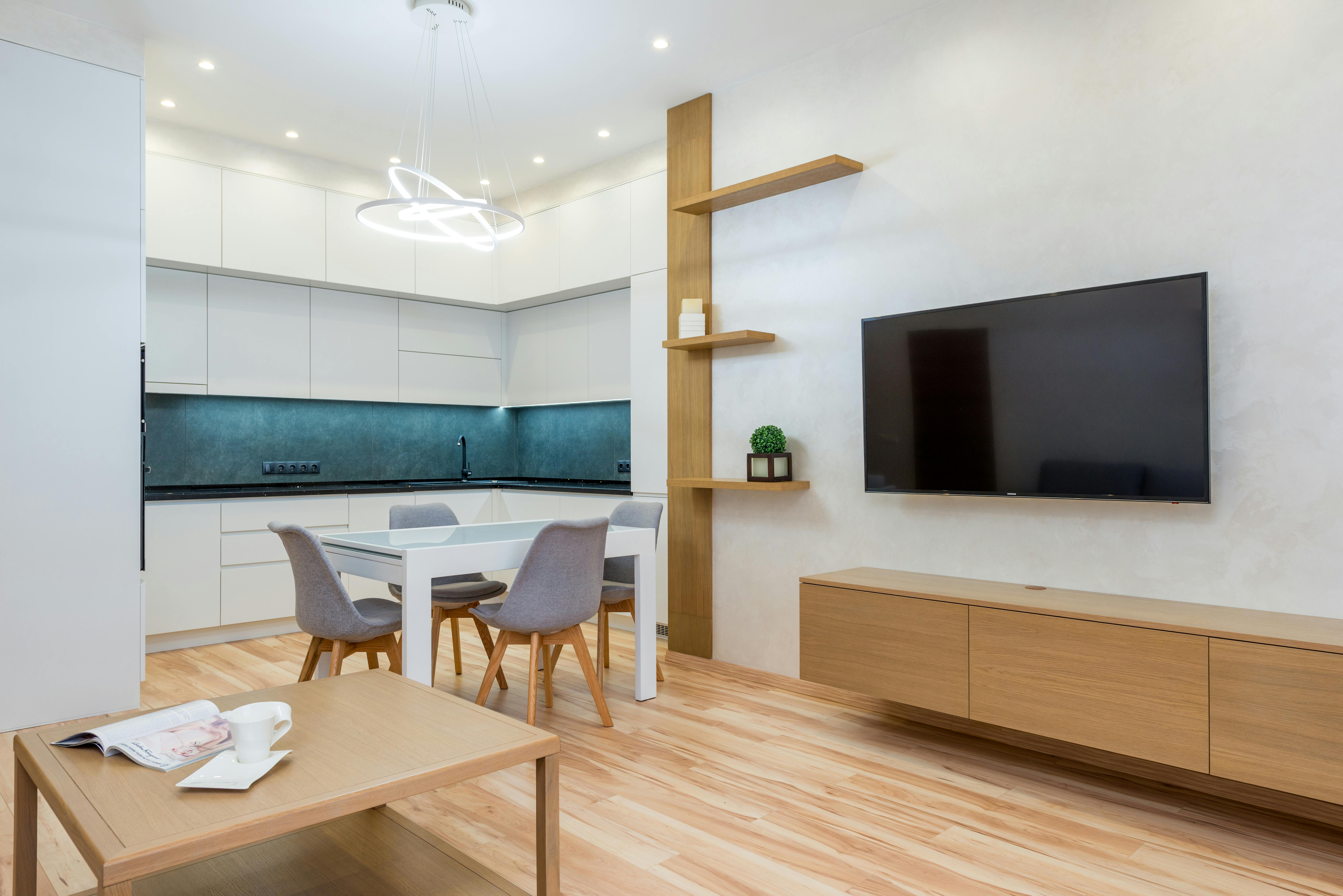 dining table next to tv and kitchen near chairs