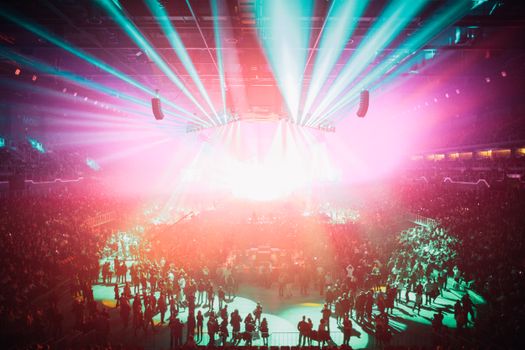 An electrifying concert scene with colorful lights and a large audience in Budapest Arena.