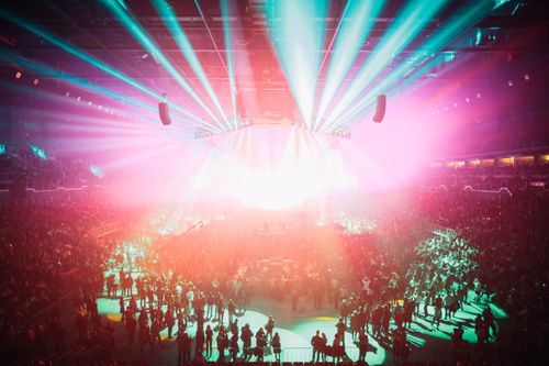 Free An electrifying concert scene with colorful lights and a large audience in Budapest Arena. Stock Photo