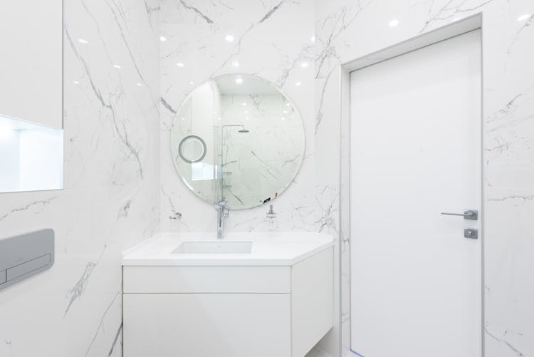 Washroom Interior With Cabinet With Sink And Mirror Near Door