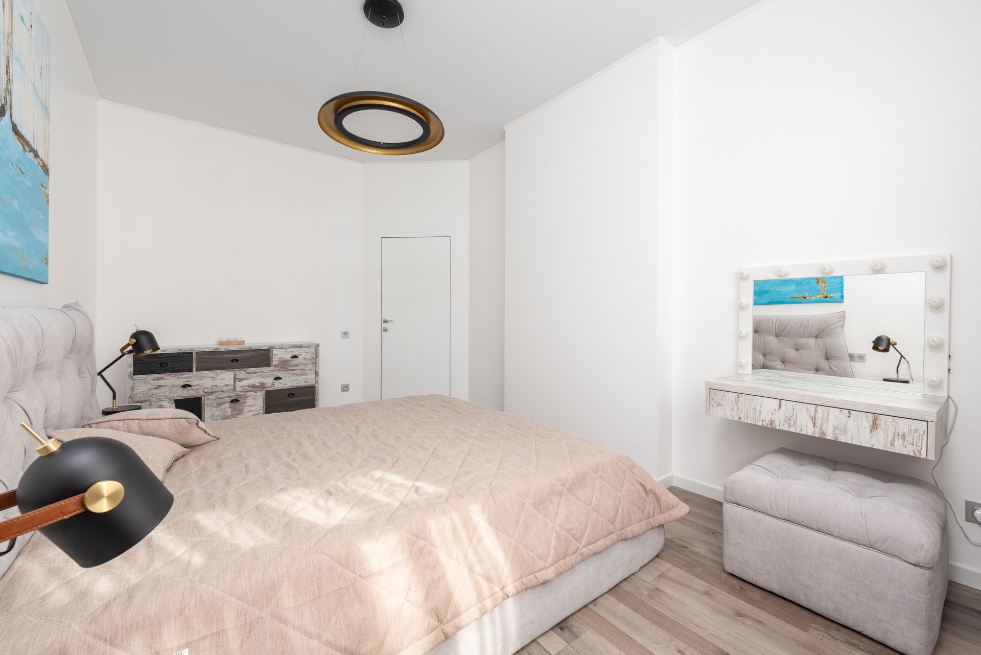 Bright minimalist bedroom featuring soft decor and contemporary furniture design.