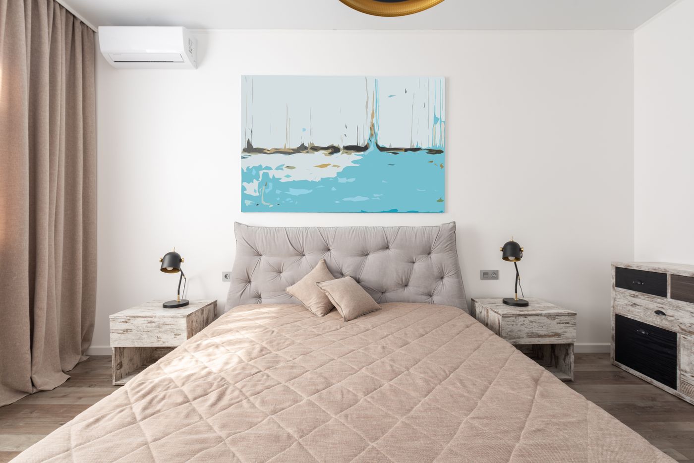 Neutral pillows and cushions arranged on soft layered bedding