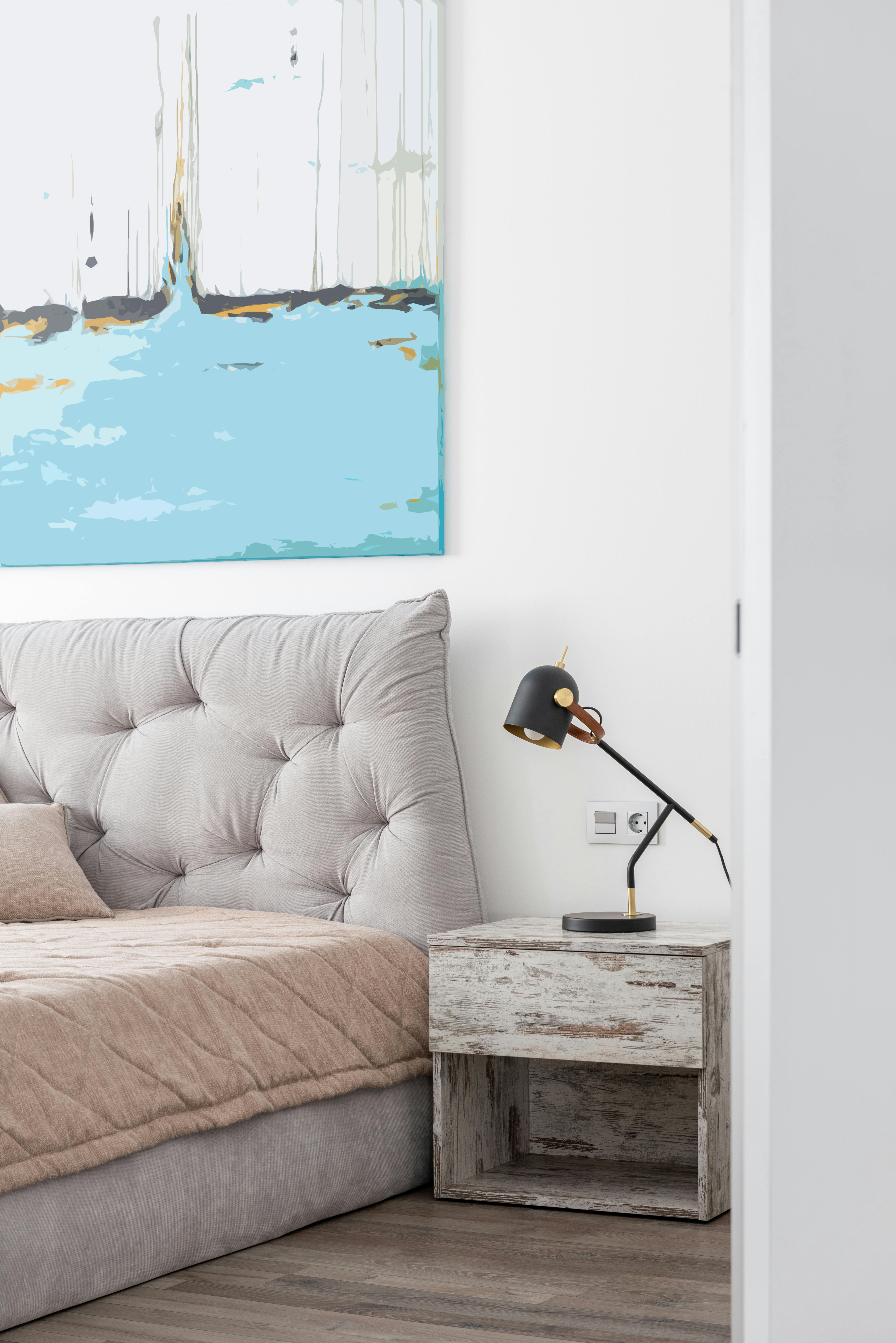 Hotel room with bed near table with lamp · Free Stock Photo