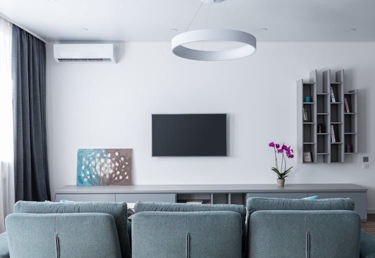 Modern Interior Of Lounge With TV And Picture On Shelf