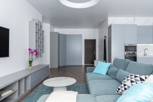 Spacious living room with a modern design featuring a cozy couch, table, and stylish decor.