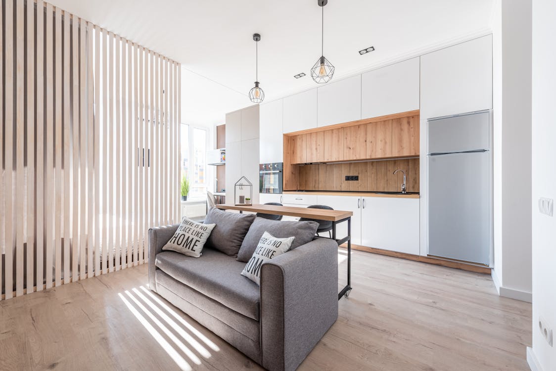 A cozy sofa with pillows placed in spacious modern lounge