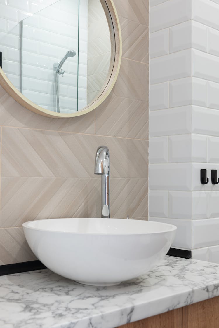 Washroom Interior With Sink And Tap On Counter Near Mirror