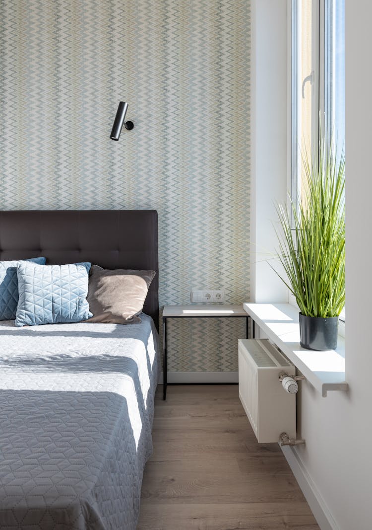 Bedroom Interior With Bed Near Table And Window