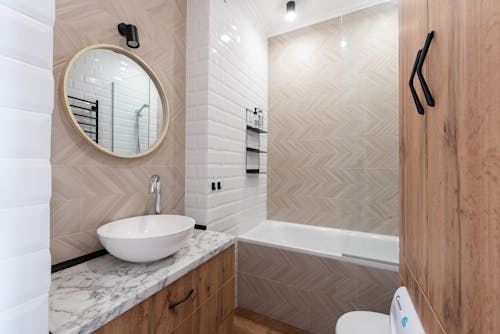 Bathroom interior with sink on counter near mirror and bath