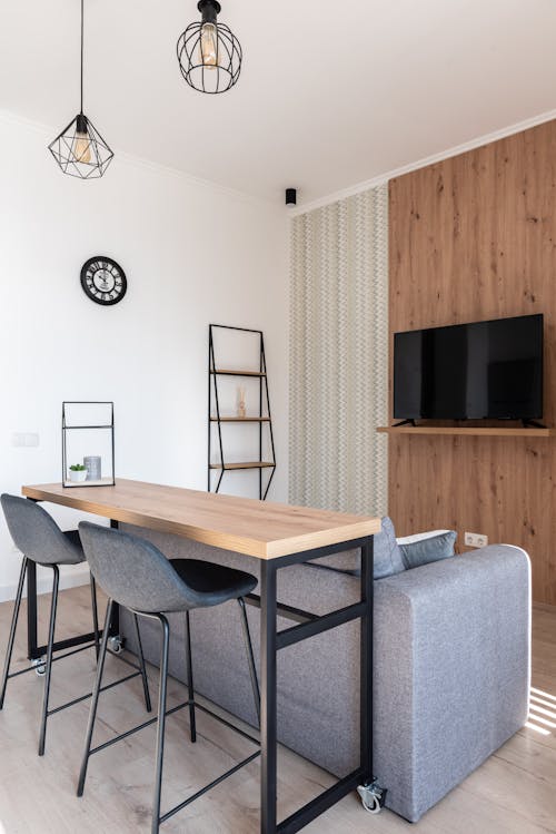 Free Apartment with table and chairs near couch with TV Stock Photo