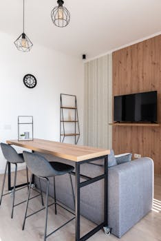 A bright, modern living room featuring minimalist furniture and decor.