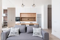 Room with sofa next to open kitchen