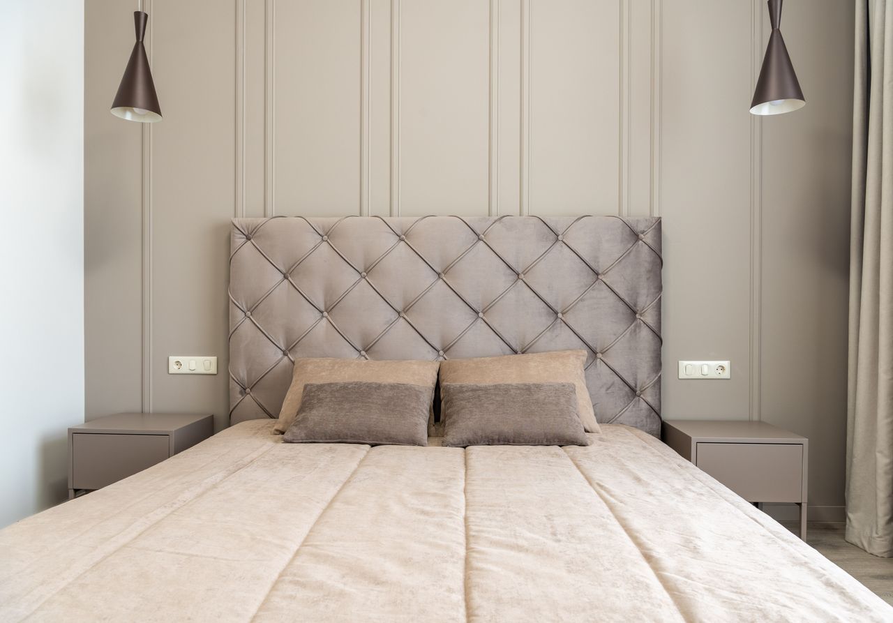 Tall tufted headboard bedroom with two gray bedside tables