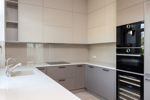 Kitchen interior with cupboards and oven near sink