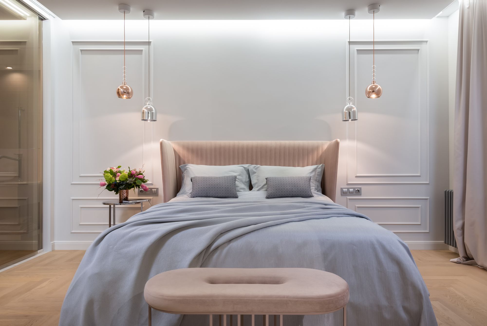 A dimly lit bedroom at night with warm bedroom wall art above the bed — bed artwork designed for sleep