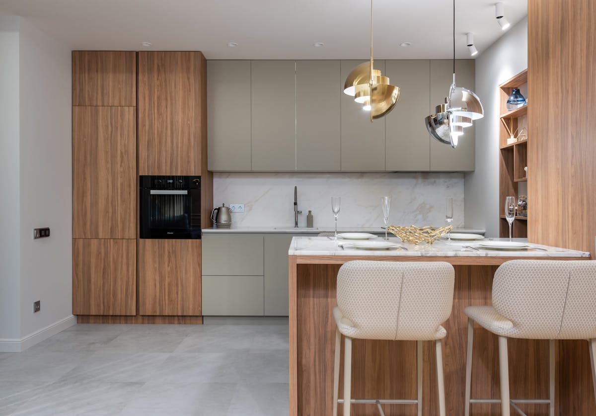 Kitchen interior with chairs and counter near cupboards
