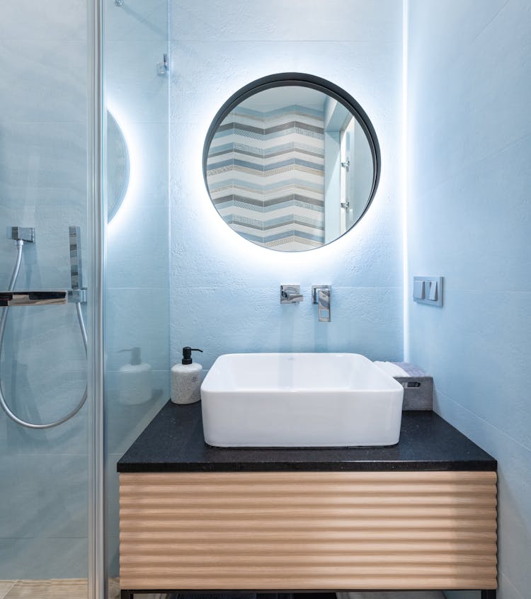 Washroom Interior With Sink And Faucet On Cabinet Near Mirror