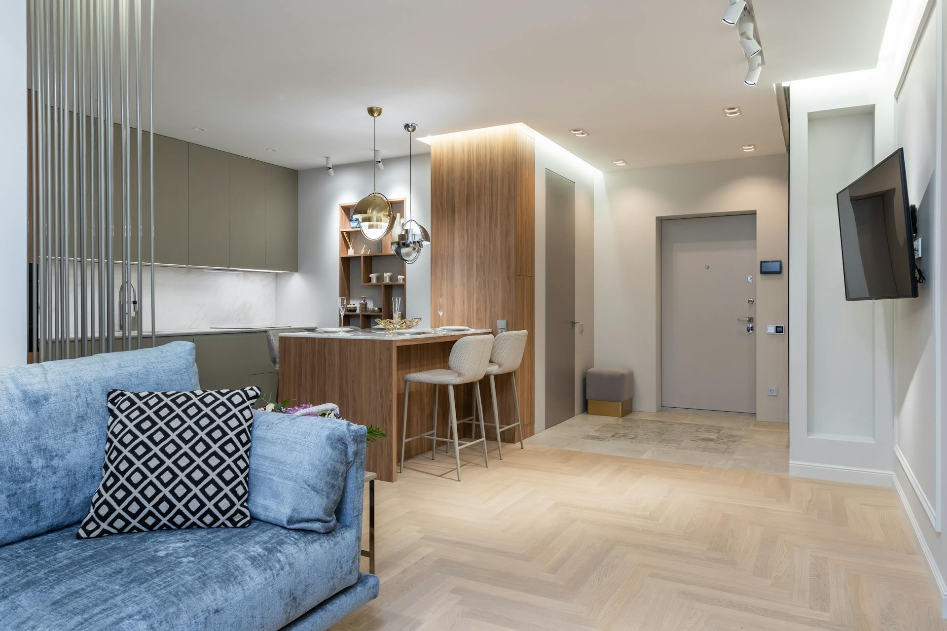 House interior with kitchen near couch and chairs with counter