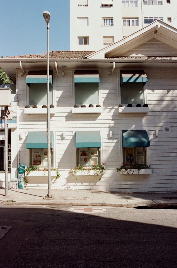 House Facades Against Road In Town On Sunny Day