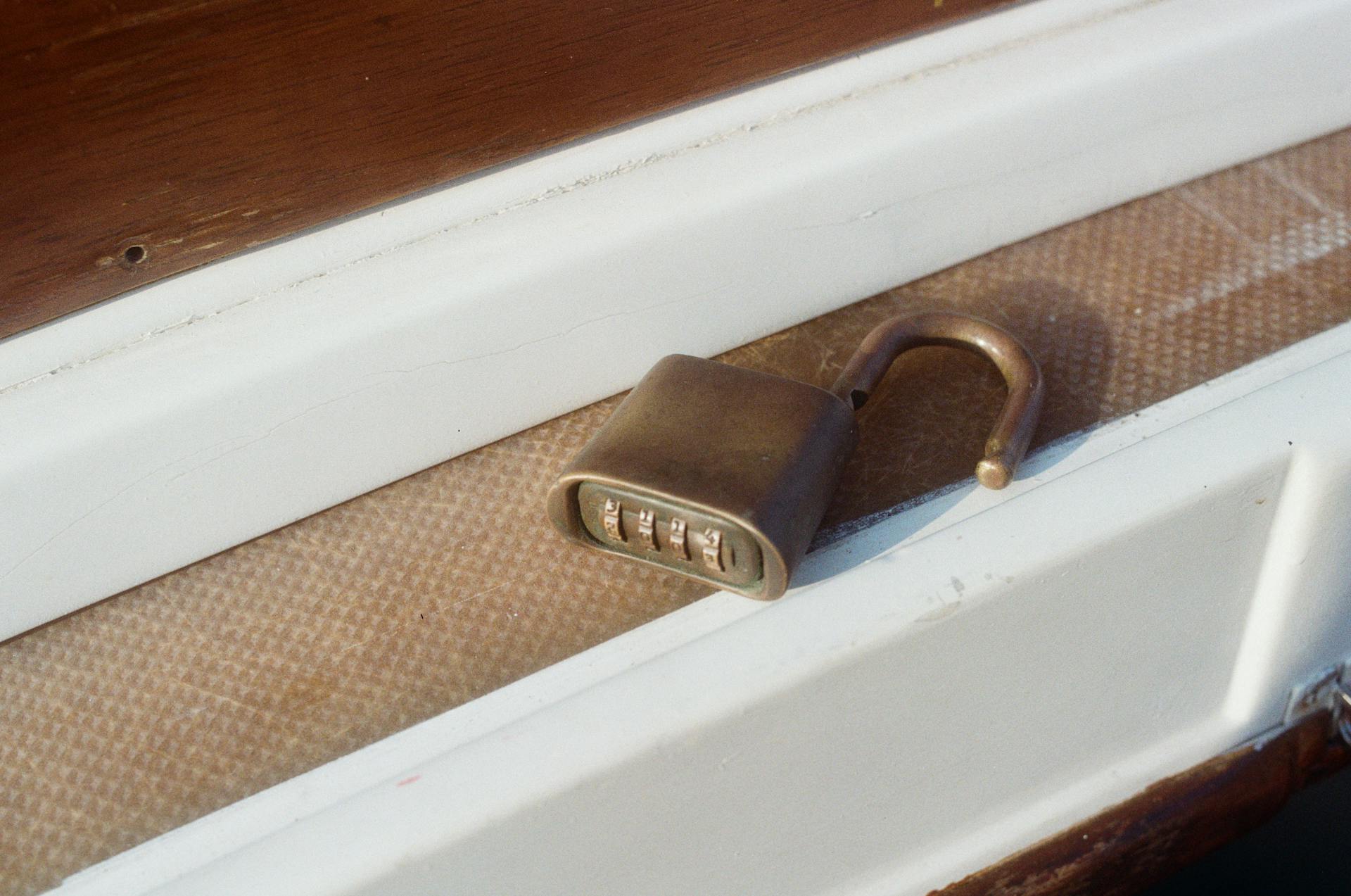 Close-up of an open combination lock on a boat deck illustrating security and protection themes.