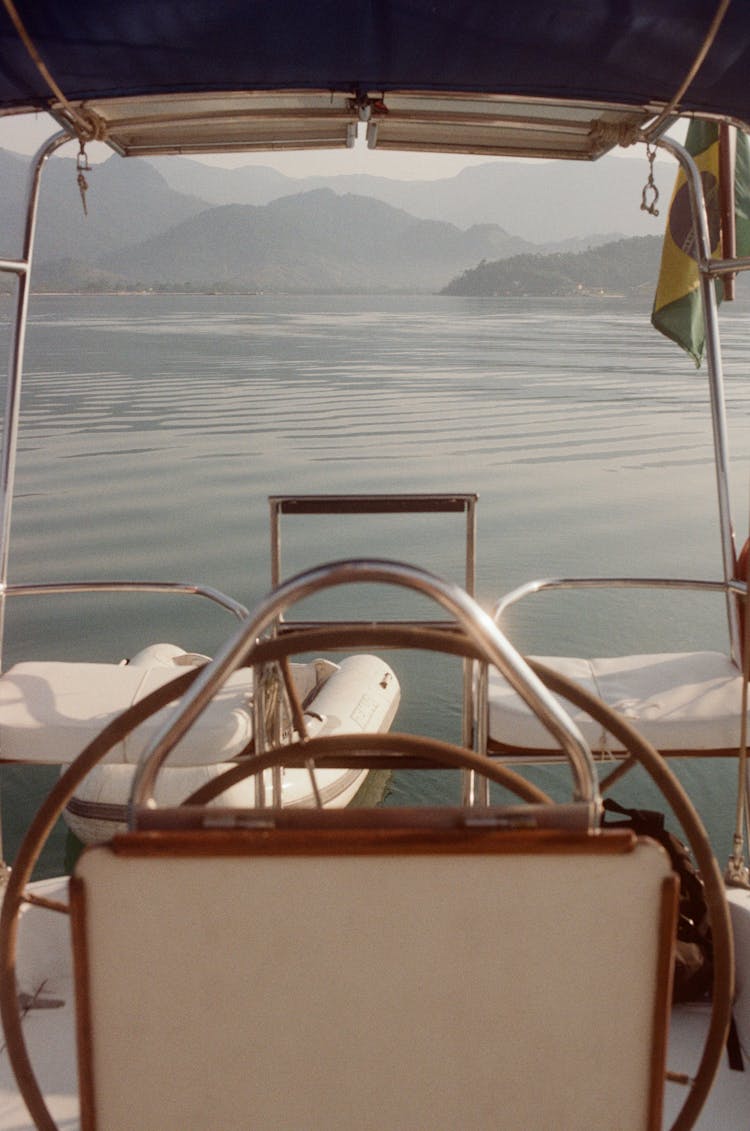 Yacht Deck With Steering Wheel In Lake