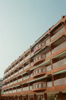 Low angle of hotel with apartments located at resort under blue cloudless sky