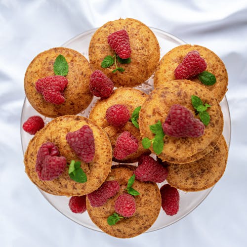 Delicious healthy pancakes with raspberries served on plate