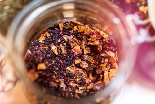 Free From above of glass jar with dry aromatic fruit tea against blurred background in daylight Stock Photo