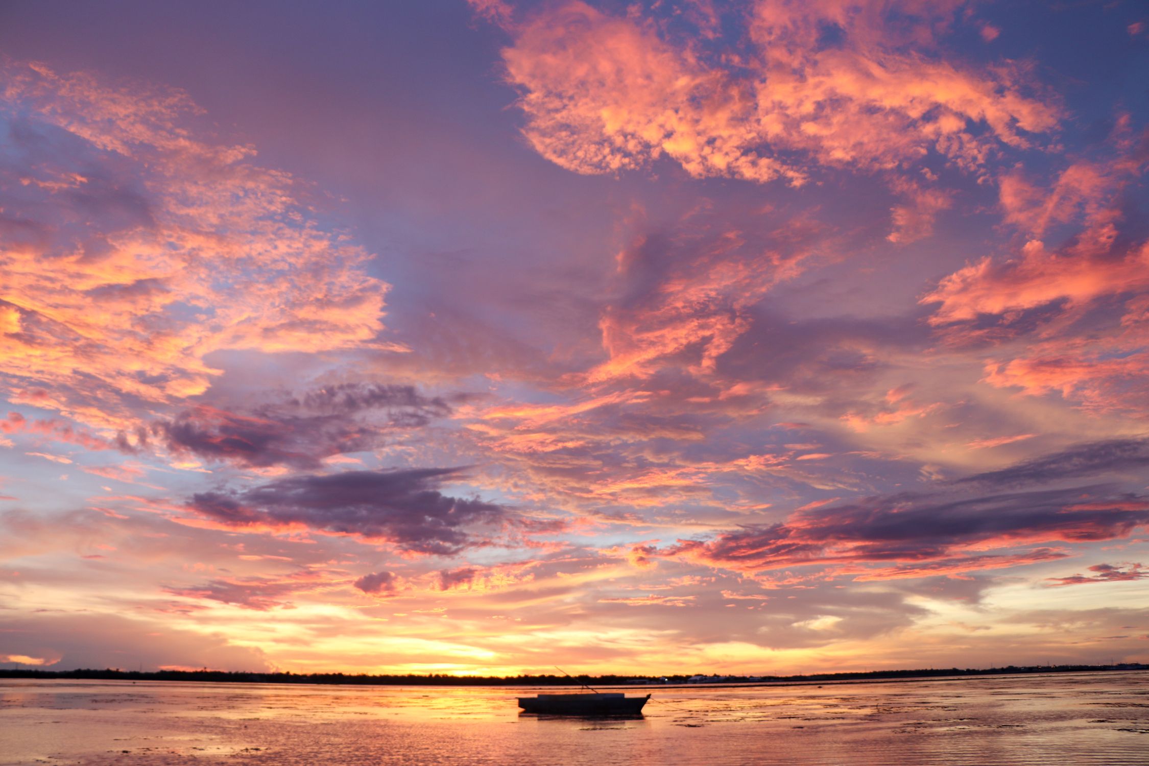 Silhouette of a Boat on the Sea during Sunset · Free Stock Photo