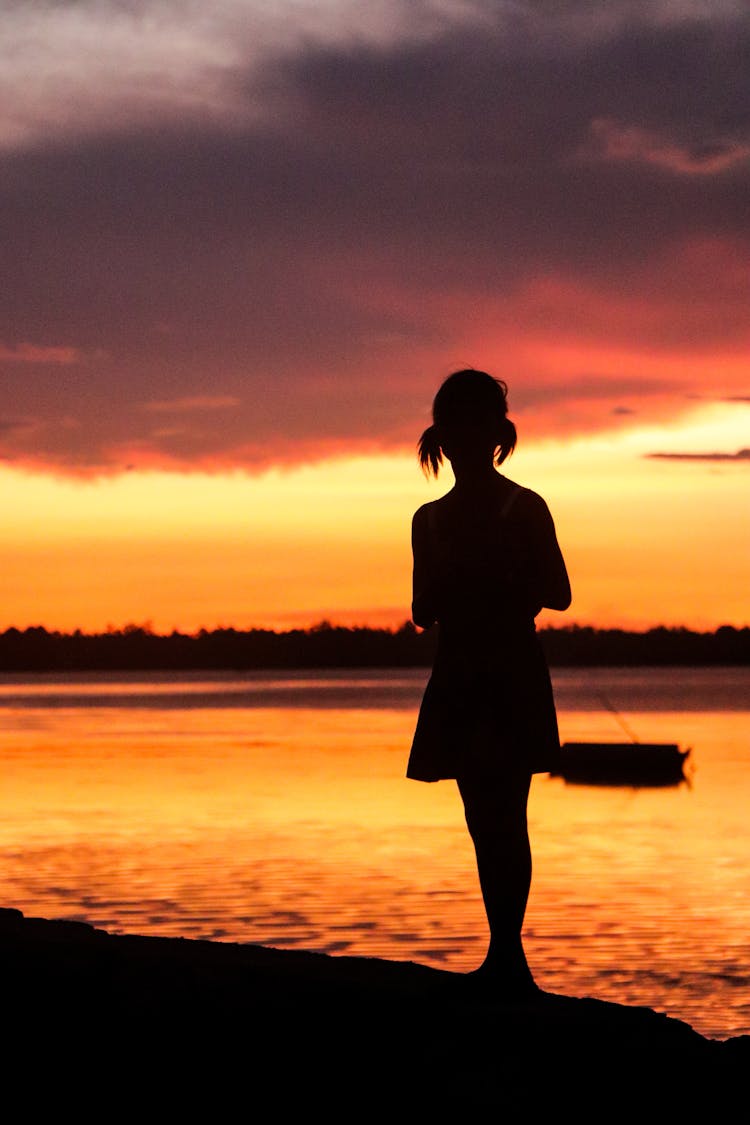 Woman Silhouette On Sea Shore At Sunset