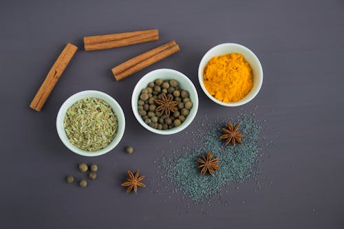Assorted Spices Near White Ceramic Bowls