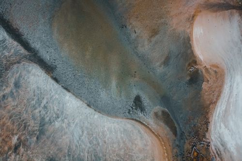 Free Picturesque drone view of wild sandy beach of powerful sea with foamy waves in daytime Stock Photo